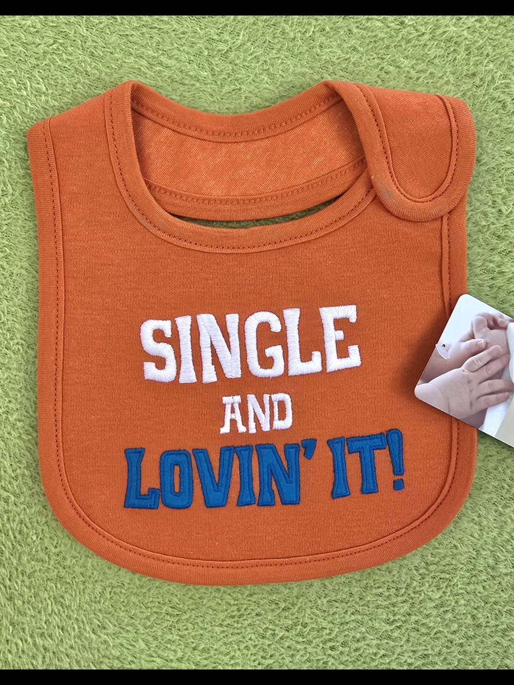 NWT Carter's Orange Bib with White and Blue Text - "Single and Lovin' It!" (Q1)